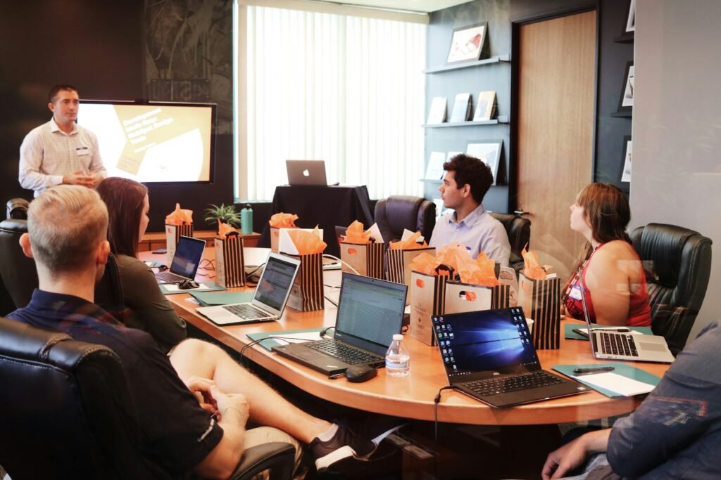 Founder presenting an investor pitch deck to a small group around a table