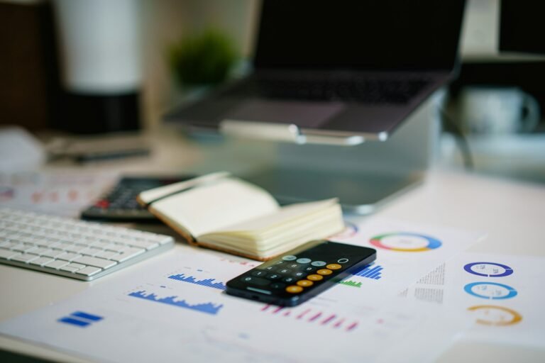 Financial report with charts and a calculator for pitch deck projections