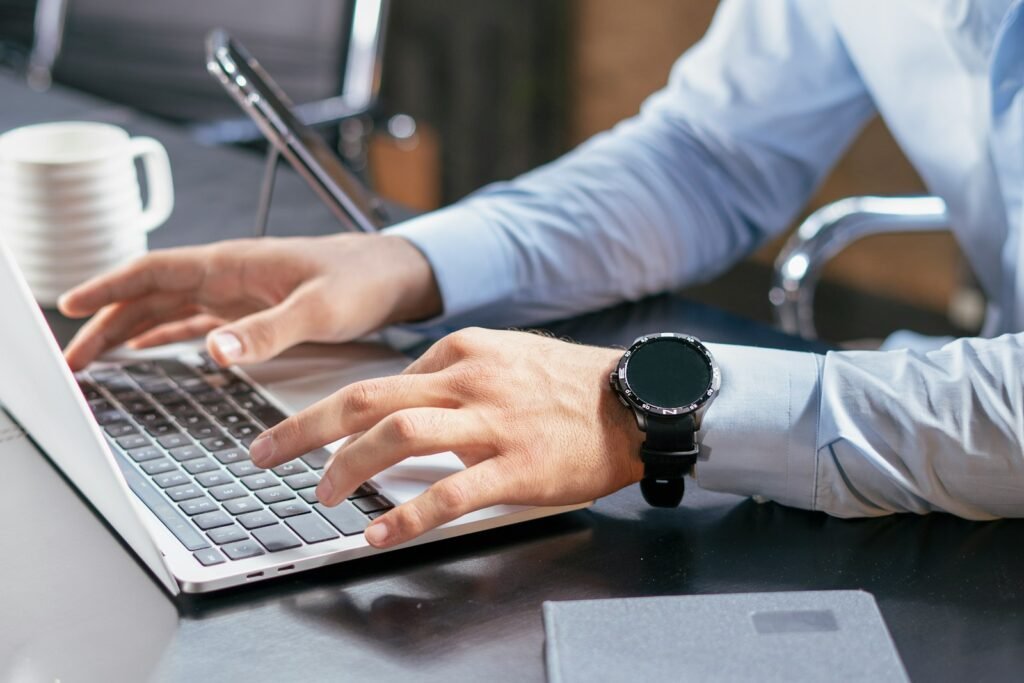 Person working on a laptop choosing between PowerPoint and Google Slides for a pitch deck