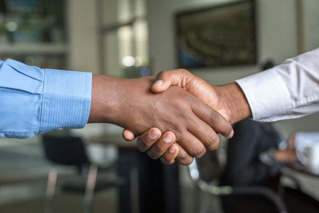 Two business people shaking hands after a sales presentation