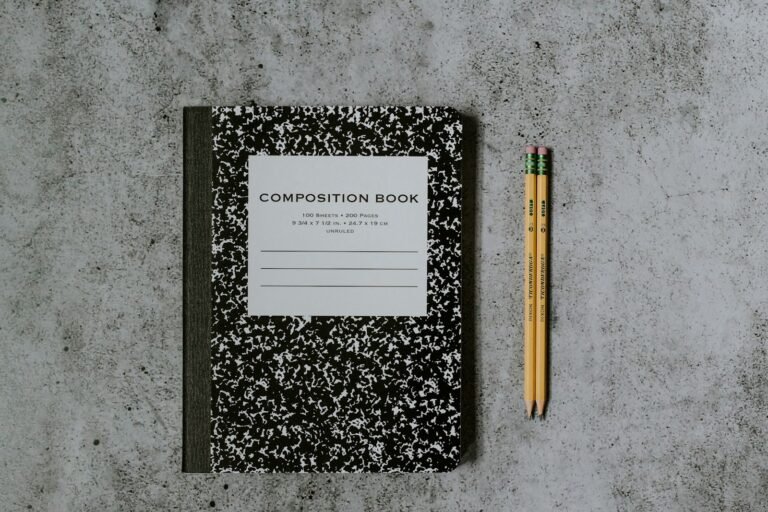 Notebook and pencils ready for writing a presentation design brief